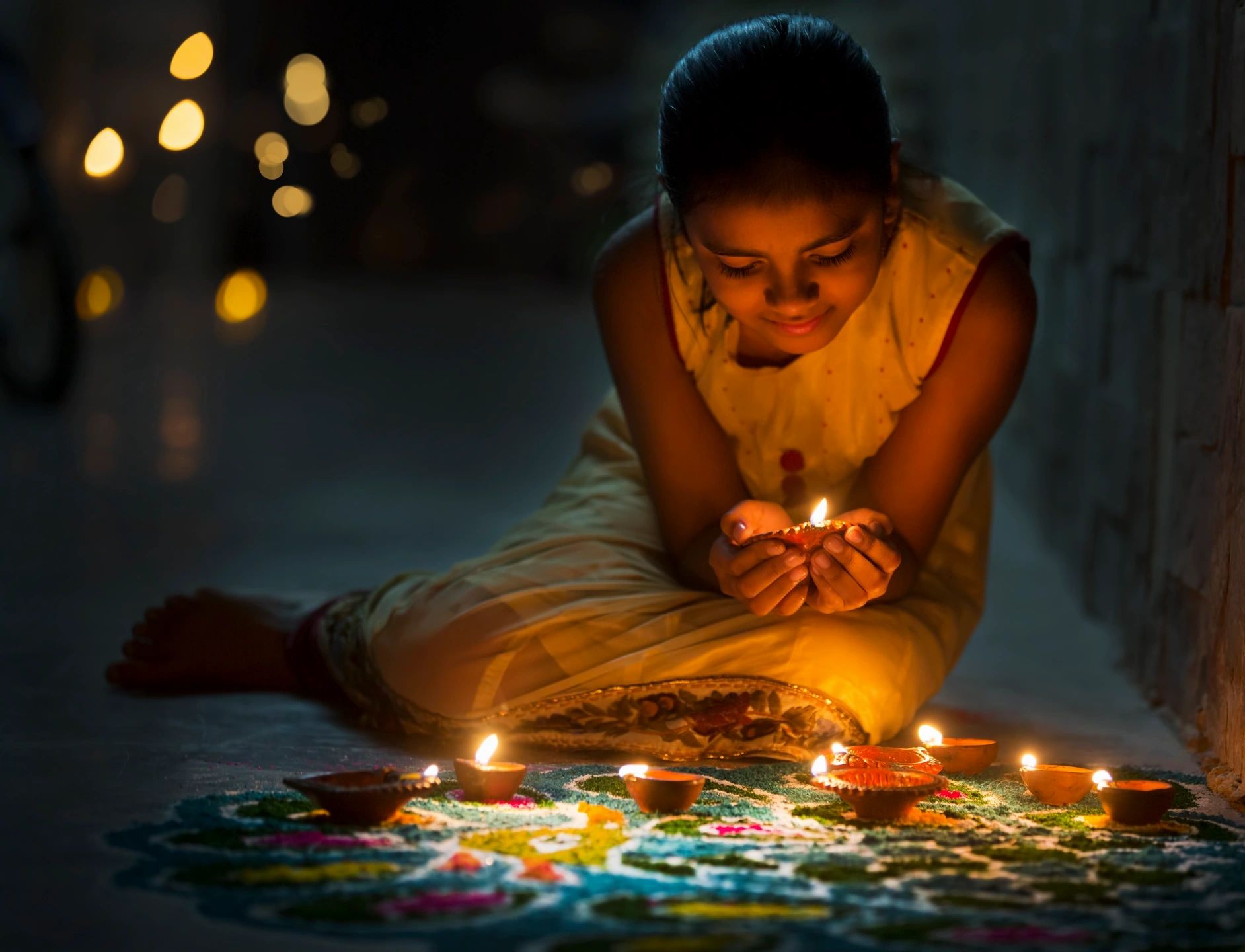 Girl holding a diya lamp during Diwali celebration