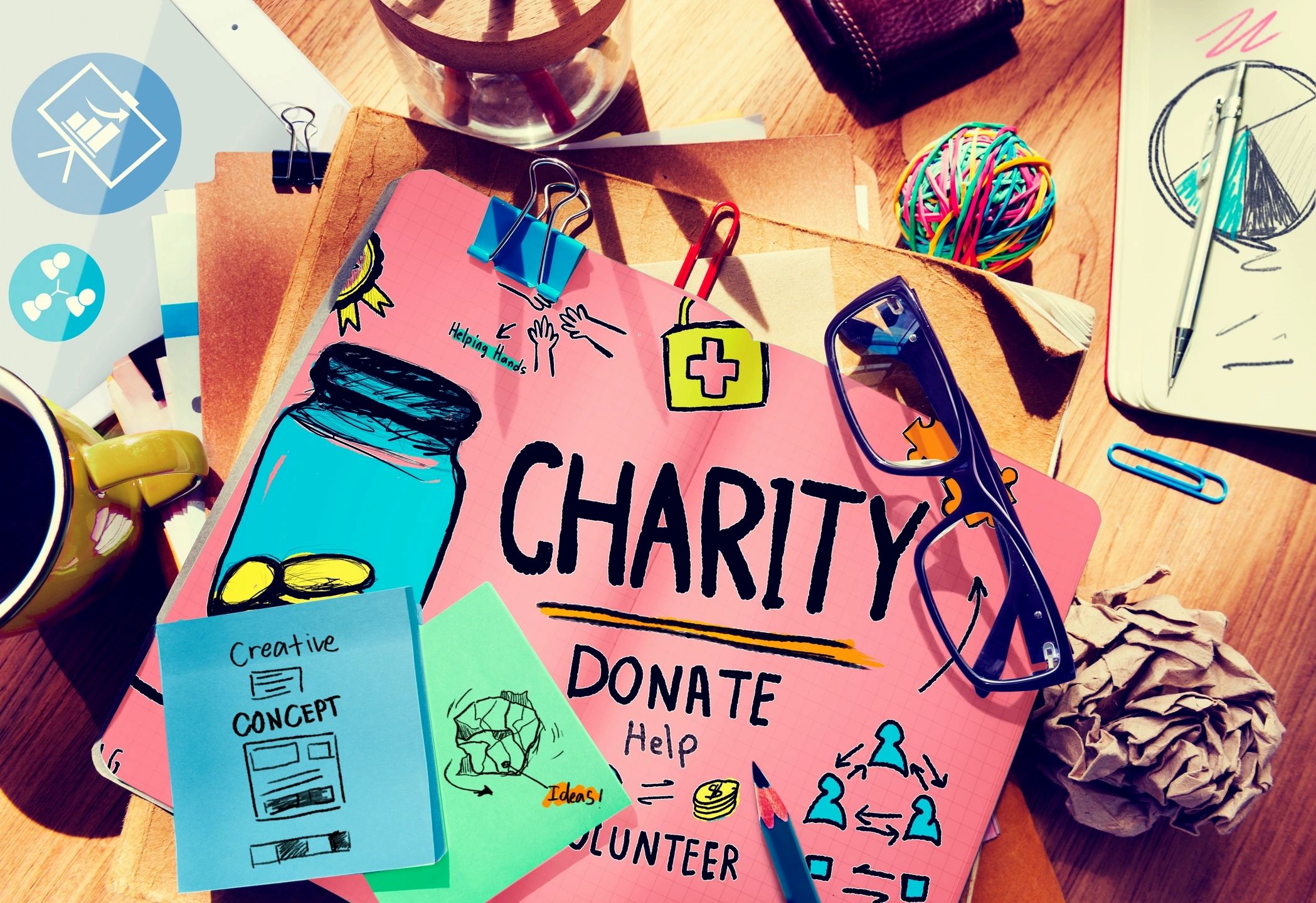 Charity planning workspace with creative concept materials